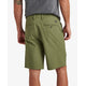 A man is wearing the Dante Short in green from REEF and a gray cotton blend shirt. He is seen from the back, hands at his sides, exuding casual comfort.
