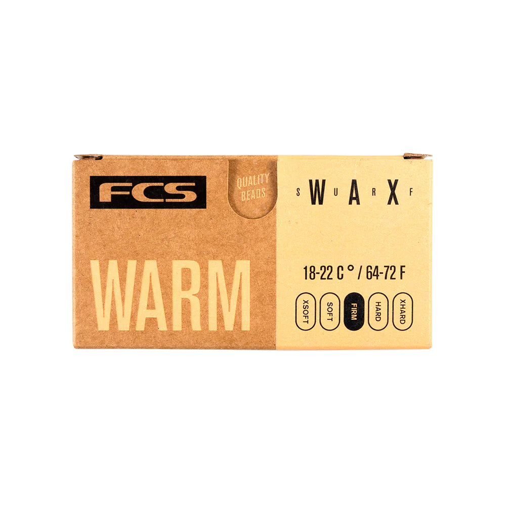 A box of FCS surfboard wax on a white background.