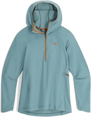 The Outdoor Research Freewheel Half Zip Hoodie W's is a light blue, long-sleeve pullover featuring a hood, a partial front zipper, and a subtle chest logo.