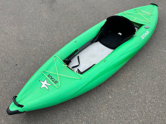 A USED STAR Paragon Solo IK Lime kayak is parked on the street.