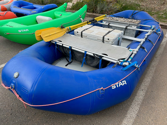 A group of Demo Outlaw 15 Packages from 4Corners Riversports parked in a parking lot.