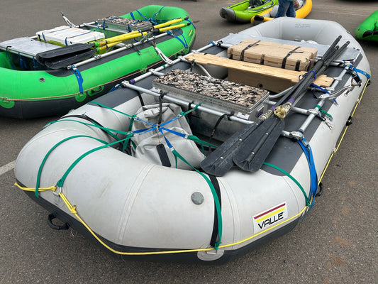 Two Valle rental fleet rafts parked in a parking lot.