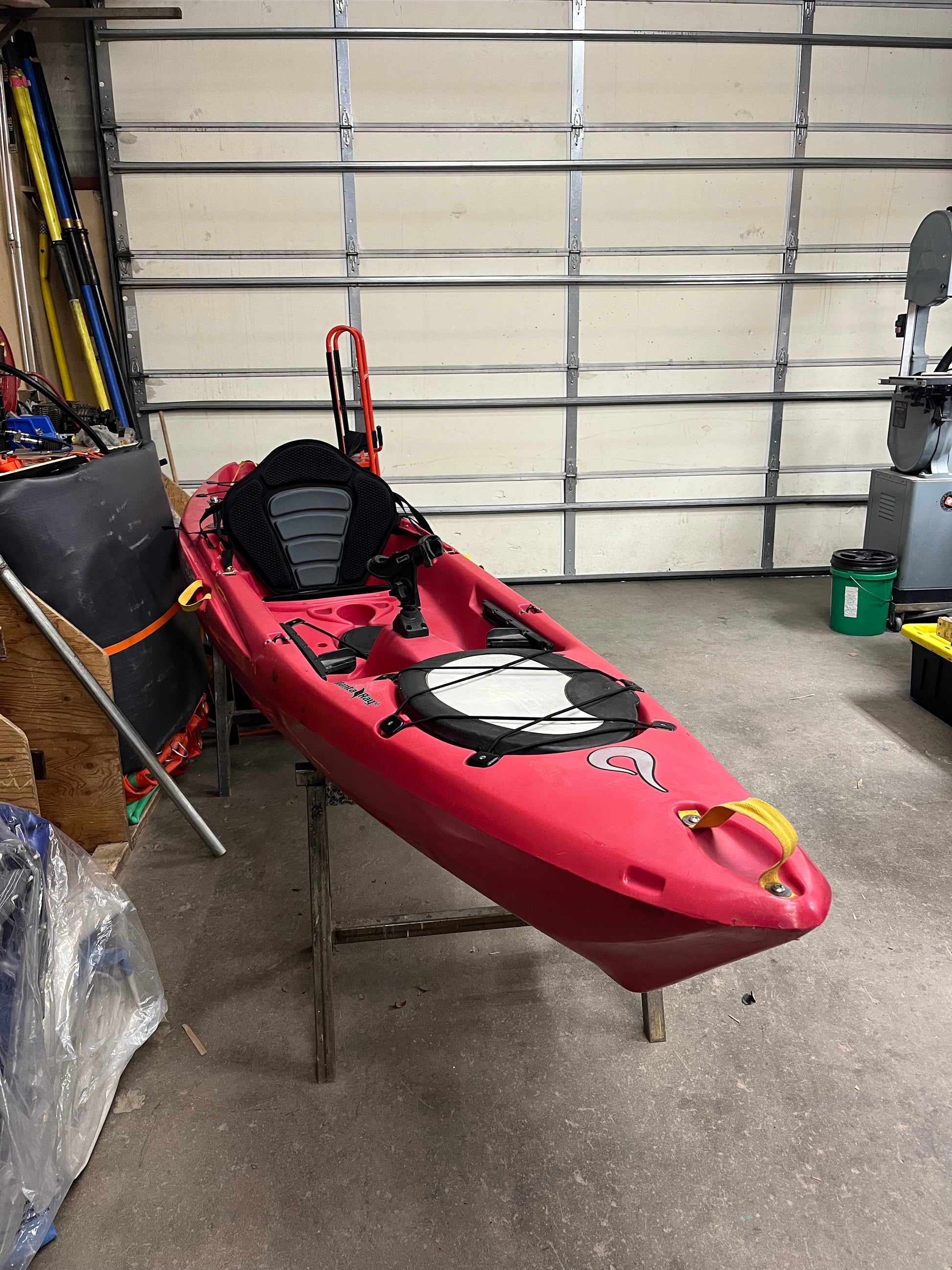 A used Coyote Consignment Manta Ray 12 sit-on-top kayak sitting in a garage.