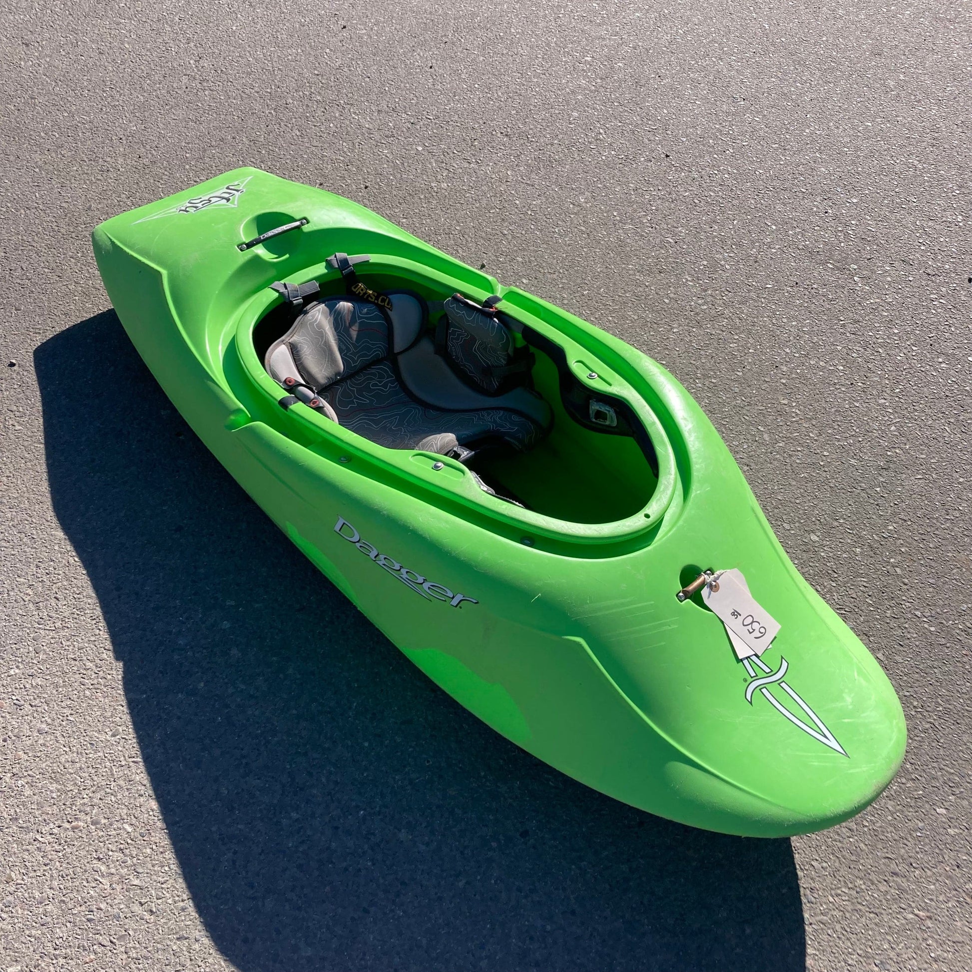 A 4CRS Consignment Jitsu 5.9 kayak is parked on the side of the road.