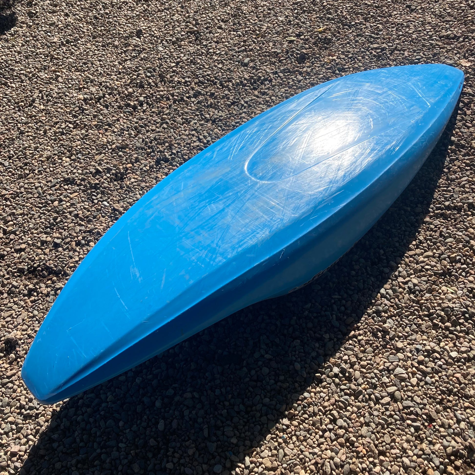 A blue Demo Homeslice kayak laying on the ground. (Brand: LiquidLogic)