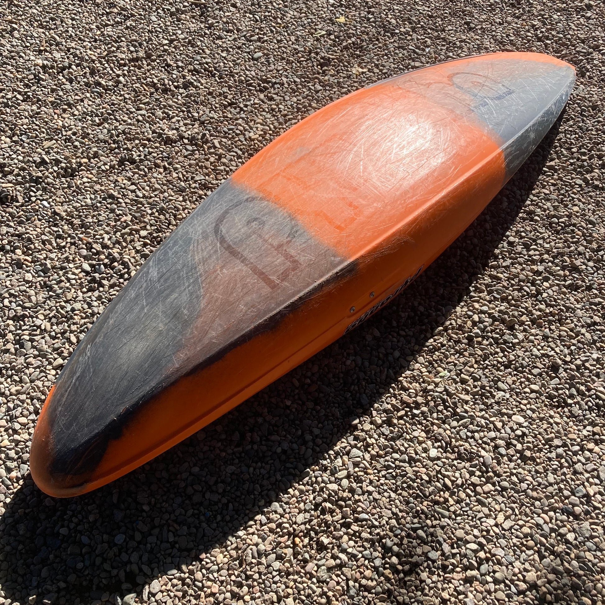 A Pyranha Demo Ripper 2.0 SM surfboard laying on the ground.