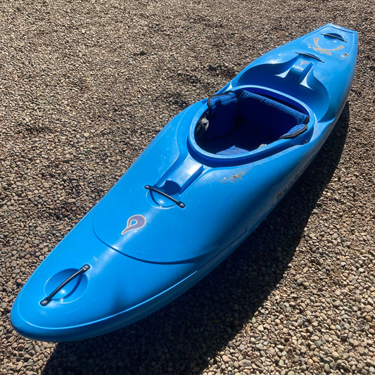 A blue LiquidLogic kayak sitting on gravel.