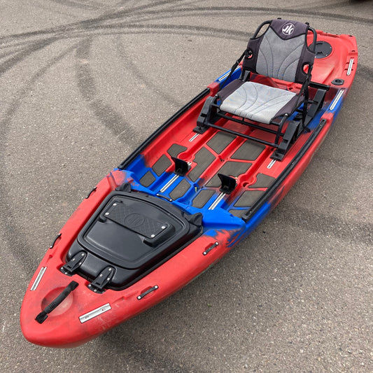 A Demo Coosa X kayak from Jackson Kayak sitting in a parking lot.