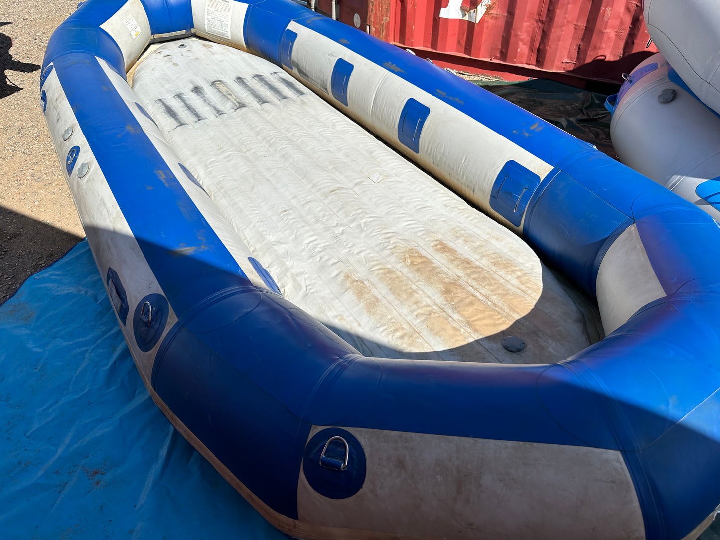 A used 16' Vanguard Raft from 2006, sitting on top of a truck.