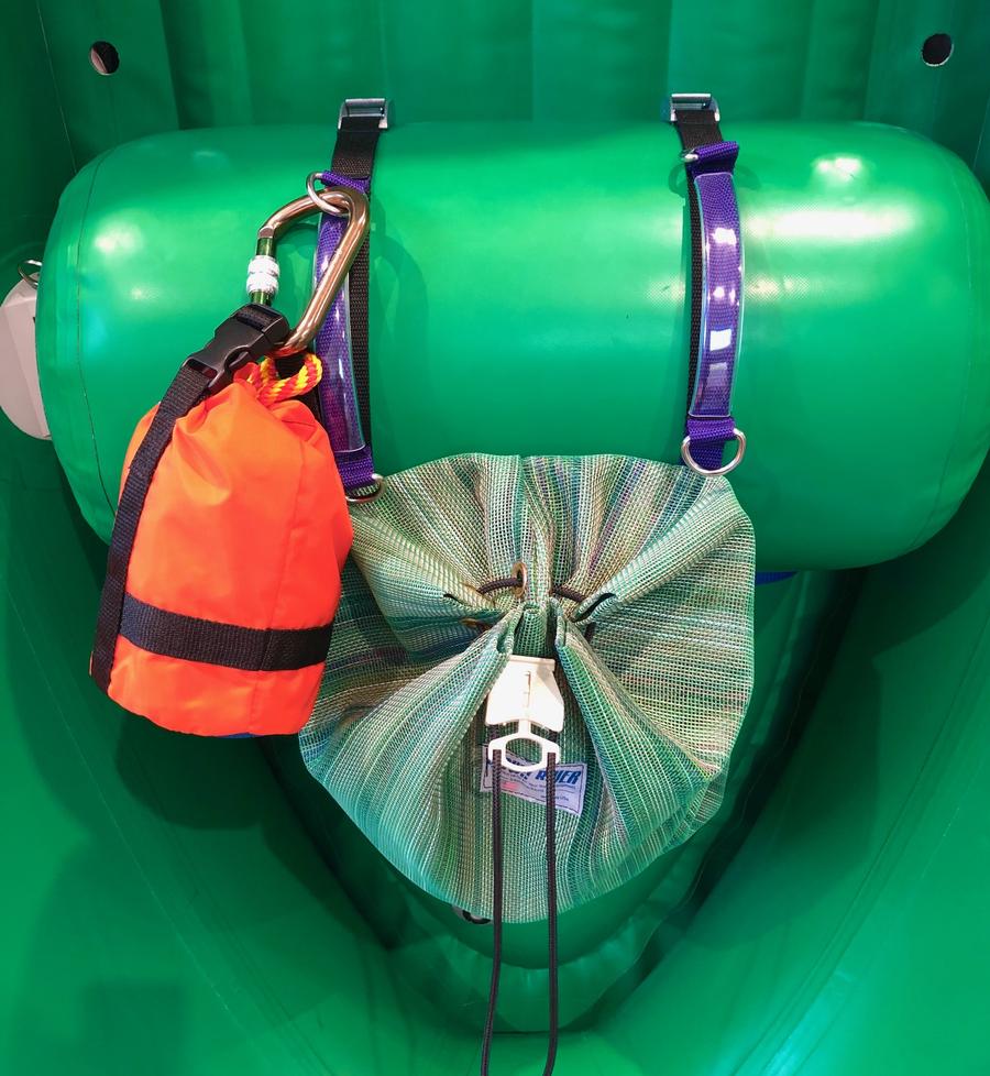 The Thwart Bag by Down River Equipment is a green inflatable boat accessory featuring a UV-resistant design with secured green and orange bags, attached using purple straps, metal clips, and a multi-mesh quick-access cinching system for enhanced convenience.