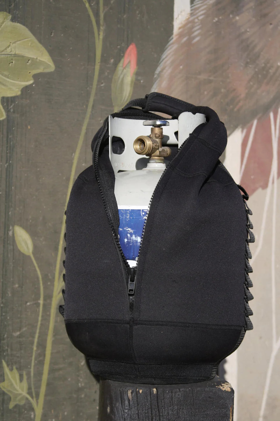 A black bag with a LavaBox Propane Tank Top on top of it, covered by a Tank Top.