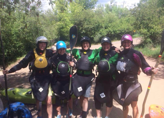 A group of people in kayaks posing for a picture during a 4CRS Paddle School women's specific Women's Kayak Class.