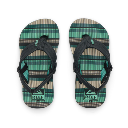 The REEF LITTLE AHI Children's Flip Flops feature black straps and green, beige, and black striped soles. Shown side by side, their durable foam outsole provides comfort—ideal kids’ sandals for daily wear.