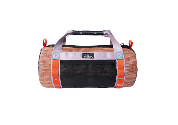 The River Station Gear Small Mesh Duffel is a small cylindrical whitewater gear bag with orange and black panels, light gray handles, and red accent loops, pictured on a white background.