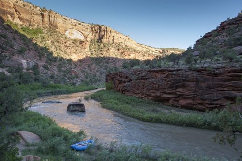 a small boat floating on top of a river.