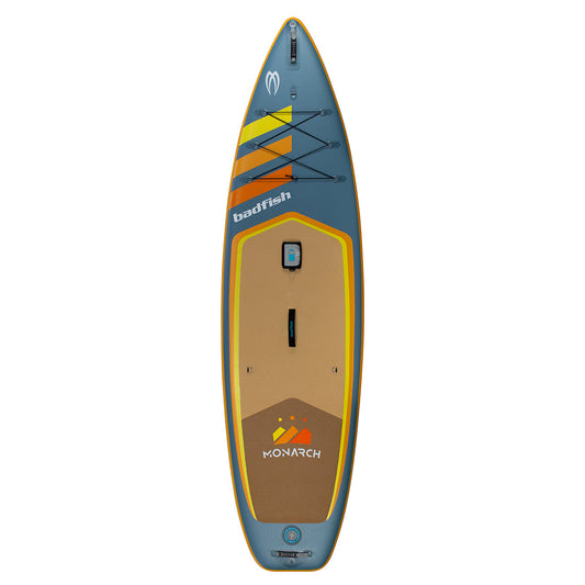 The Badfish Monarch Package inflatable paddleboard in blue and tan with orange and yellow accents is shown from above on a white background, featuring "badfish" and "Monarch" branding for standout style.