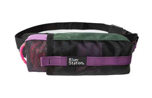 The GuideLaunch Waist Throw Bag by River Station Gear features a rectangular shape with black mesh, green and purple fabric, a pink rope handle, and a "River Station Gear" label.