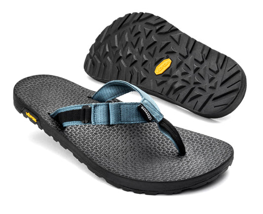Bedrock Rockhound Sandals: a pair of black flip-flops with textured soles and blue adjustable straps—one shown from the side, the other highlighting the tread. Water-ready for comfort and versatility.