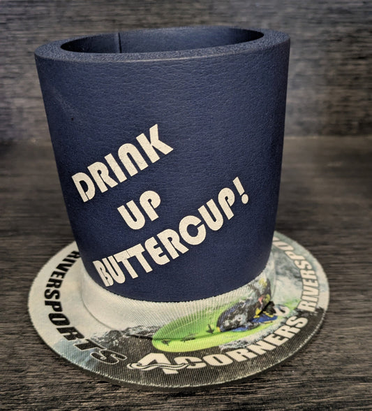 A blue 4CRS Lil' Sucker Boozie suction drink holder with "DRINK UP BUTTERCUP!" sits on a branded graphic coaster.
