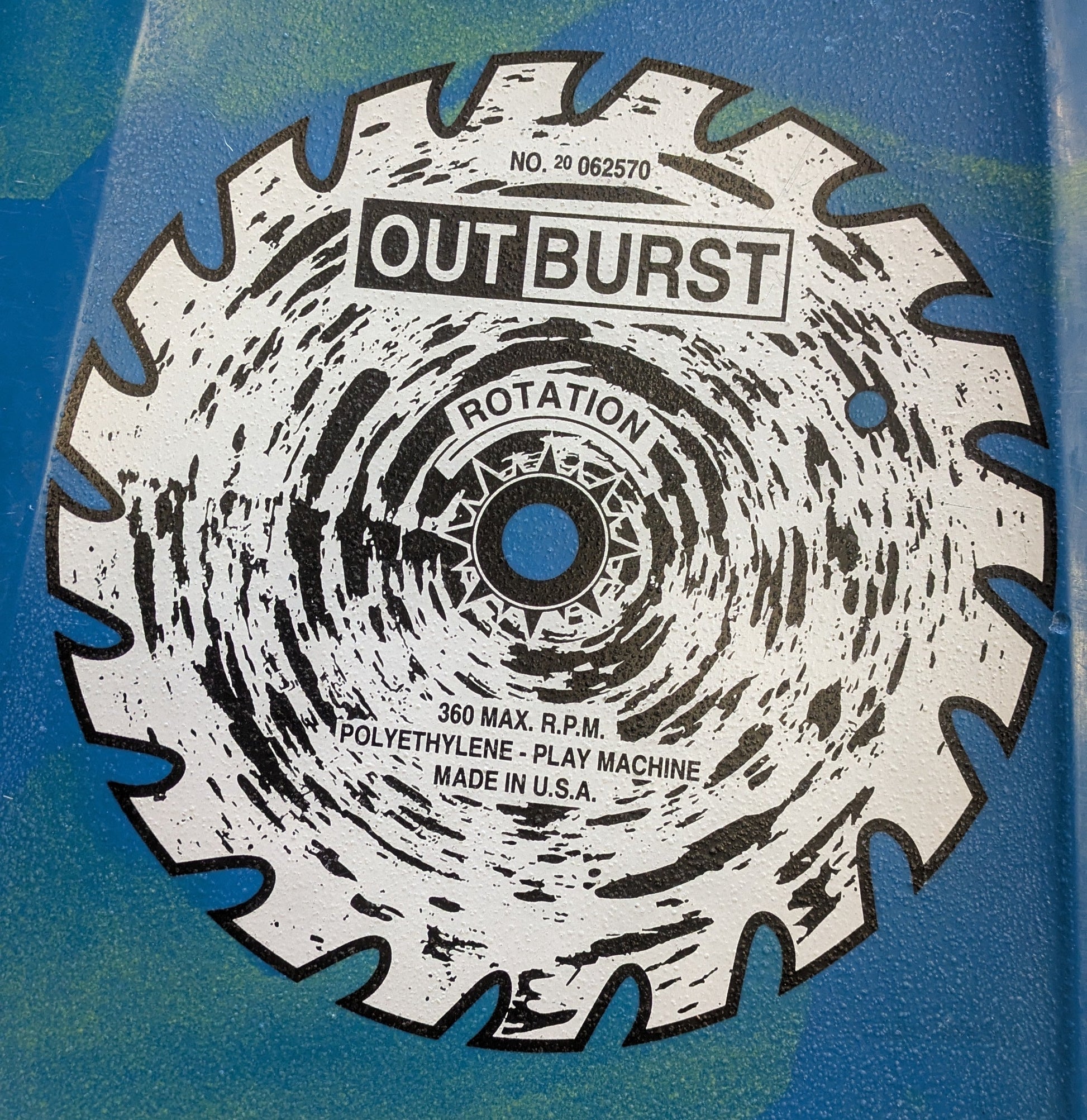Close-up of a Dagger Sawblade Outburst by 4Corners Riversports, featuring saw blade graphics with "OUT BURST," rotation direction, 360 max RPM, and "Polyethylene - Play Machine Made in U.S.A."—evoking this barely used river runner’s precision.