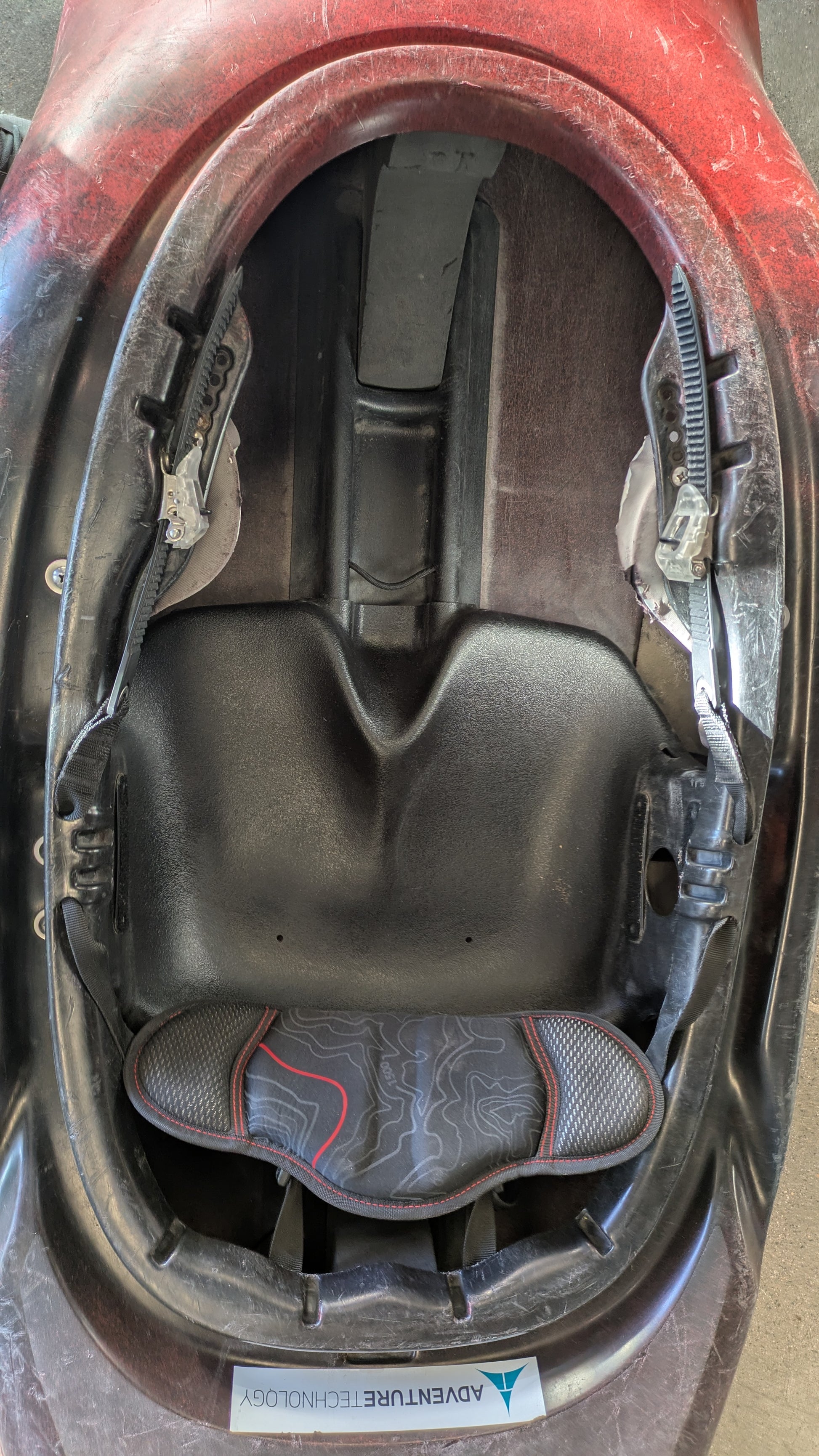 Interior view of a 4CRS Consignment Rockstar 4.0 kayak showing the seat, backrest, foot rests, padding, and a sticker labeled "ADVENTURE TECHNOLOGY.