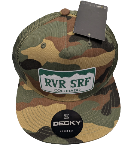 The Rvr Srf Hat by 4Corners Riversports is a camouflage snapback with a "RVR SRF Colorado" patch and "DECKY ORIGINAL" sticker on the brim—perfect for river surfing fans. Comes with a price tag attached to the top.