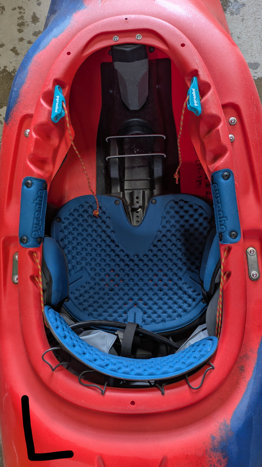 Top view of the Pyranha Demo Helectron kayak cockpit, highlighting the seat, padding, footrests, and safety straps—a great choice for anyone seeking a reliable used kayak from our demo fleet.