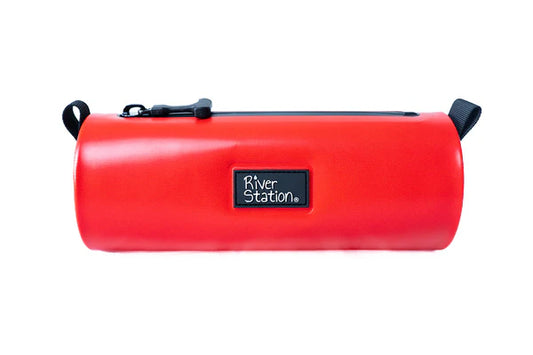 The Drylap Kayak Dry Bag by River Station Gear is a cylindrical red waterproof bag with a black zipper, logo patch, and black carrying loops on each end—ideal for kayaking.