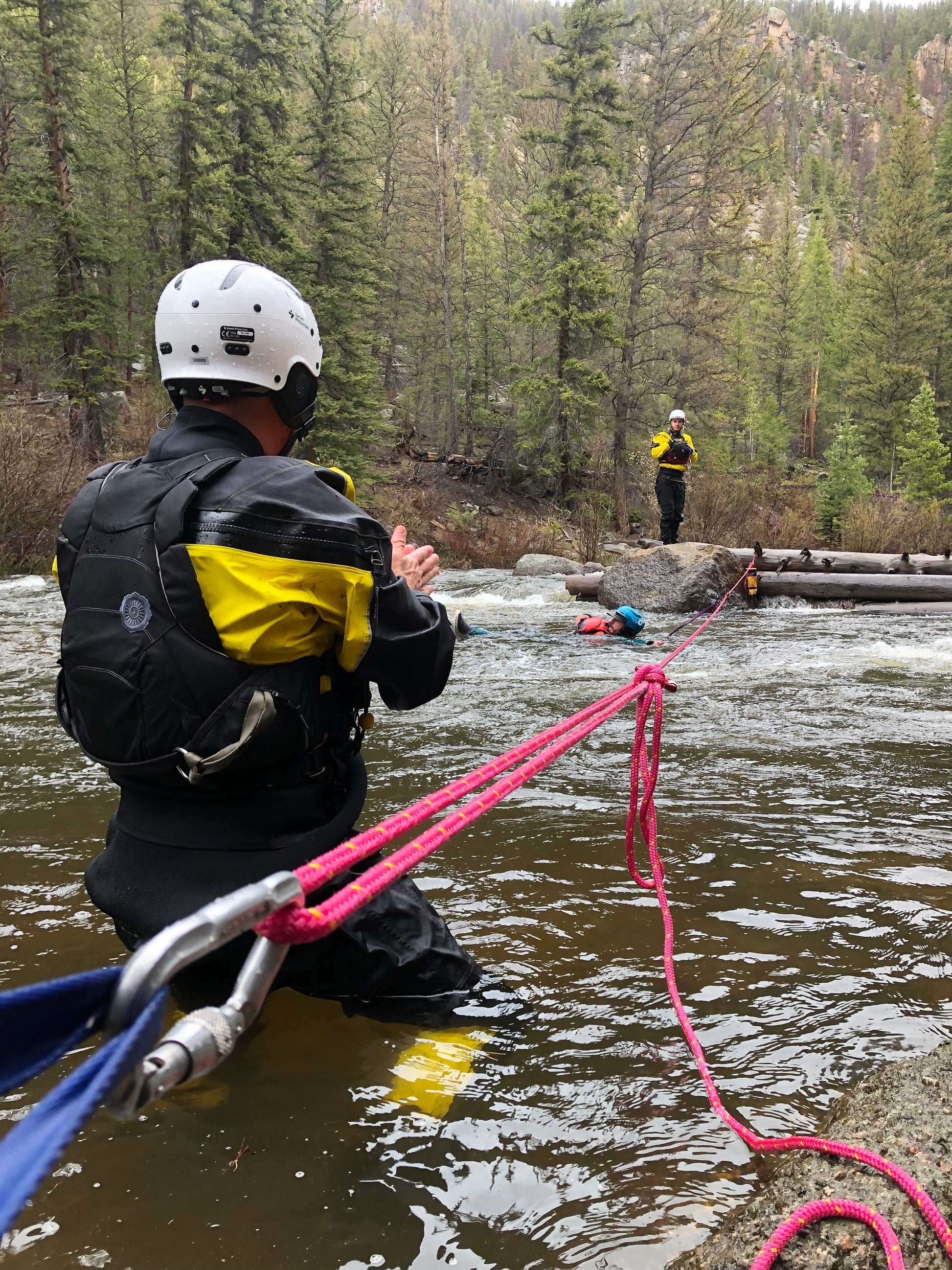 A group of 4CRS Paddle School instructors exhibiting excellent technical knowledge while teaching skills on a rope in a river during the Swiftwater Rescue ACA Instructor Course.
