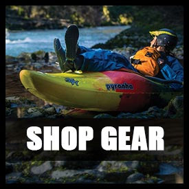 a man laying on top of a kayak on a river.