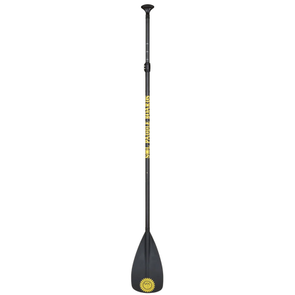 The Carbon Blaster 3-Piece Travel SUP Paddle by SOL Paddle Boards is black with a yellow sun logo and "GLOBAL BREAKERS" on the carbon shaft, featuring an ergonomic handle, wide flat blade, and adjustable length for convenience.