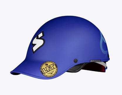 The Strutter Helmet by Sweet Protection is blue with a white "S" logo on the front and a gold certification sticker on the side.