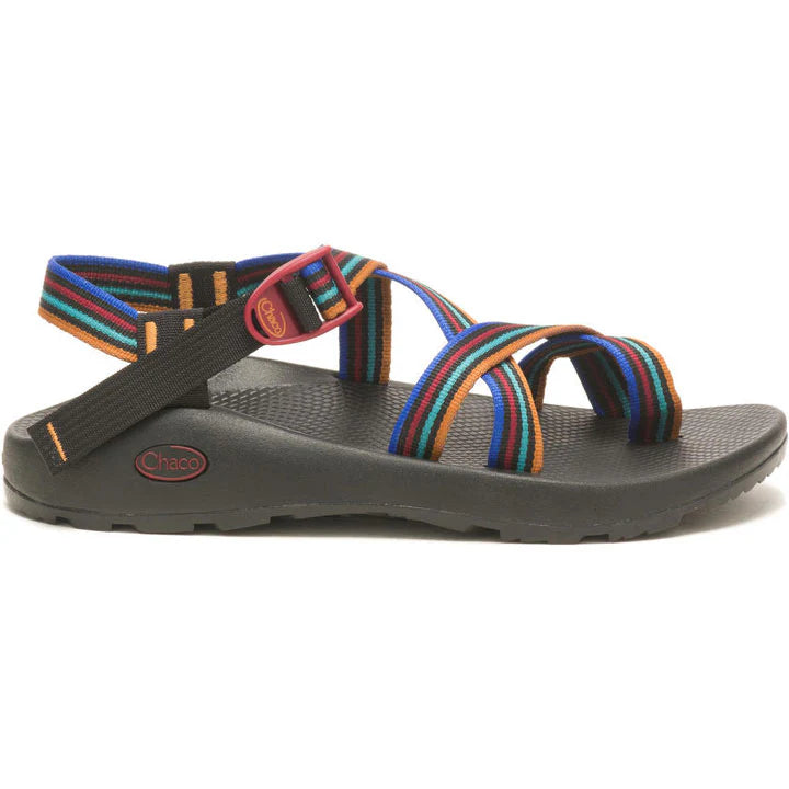 The Chaco Z2 Classic - Men's sandal, shown from the side with a black sole and multicolored striped straps plus a red buckle, highlights its supportive footbed for lasting comfort.