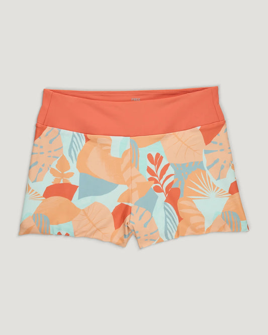 The Free Fly Wavebound Surf Short- W's showcases a coral waistband and tropical leaf print in TideKnit fabric made from recycled ghost fishing nets, styled flat against a neutral backdrop.