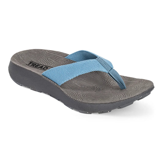 The Women's Orleans Sandal by Tread Labs features gray flip-flop styling with blue 3D knitted fabric straps, a textured dark gray sole, anatomical arch support, and a slight wedge heel.