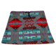 The FunLuvin' Fleece Skirt by FunLuvin' Fleecewear showcases a tribal geometric pattern in red, turquoise, and purple on a gray background. It features a comfortable elastic waistband and is crafted from anti-pill fleece for lasting wear.