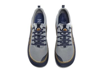Top view of a pair of Brewer 3.0 sneakers by Astral, featuring a gray and navy color scheme with hydrophobic canvas ideal for kayakers, a zippered design around the sole and eyelets, and branded logo on the tongue.