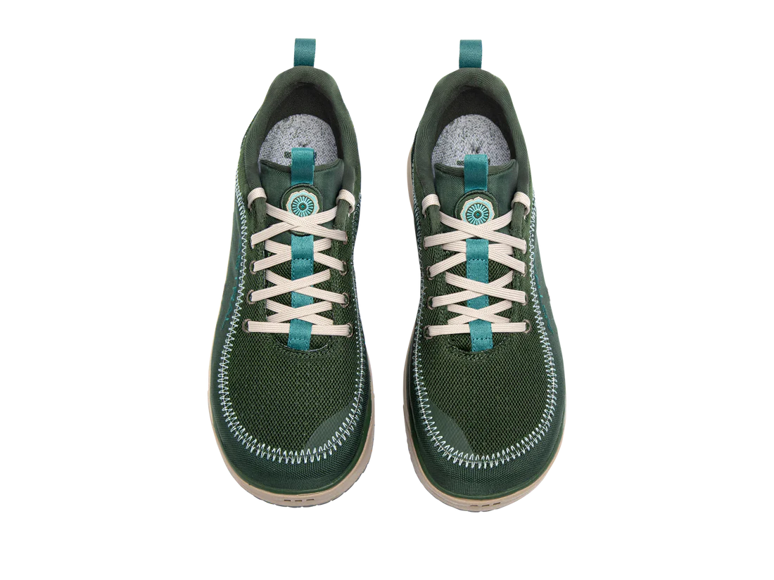 The Astral Brewer 3.0, green sneakers with beige laces, are made from hydrophobic canvas with a textured surface and white stitching. Ideal for kayakers seeking stylish yet practical footwear for water adventures.