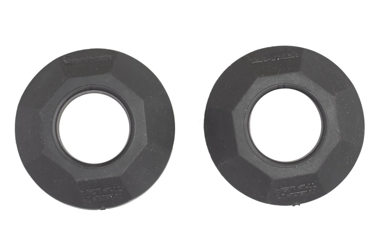 Two identical CatchNRelease™ Drip Rings by YakAttack, made of black plastic with hexagonal edges and central holes, are shown side by side on a white background.