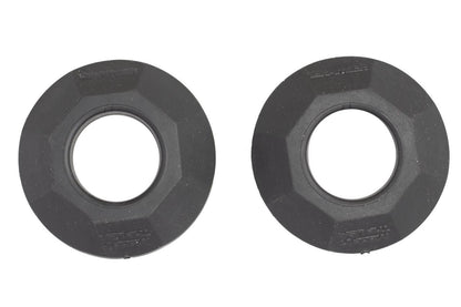 Two identical CatchNRelease™ Drip Rings by YakAttack, made of black plastic with hexagonal edges and central holes, are shown side by side on a white background.