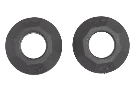 Two identical CatchNRelease™ Drip Rings by YakAttack, made of black plastic with hexagonal edges and central holes, are shown side by side on a white background.