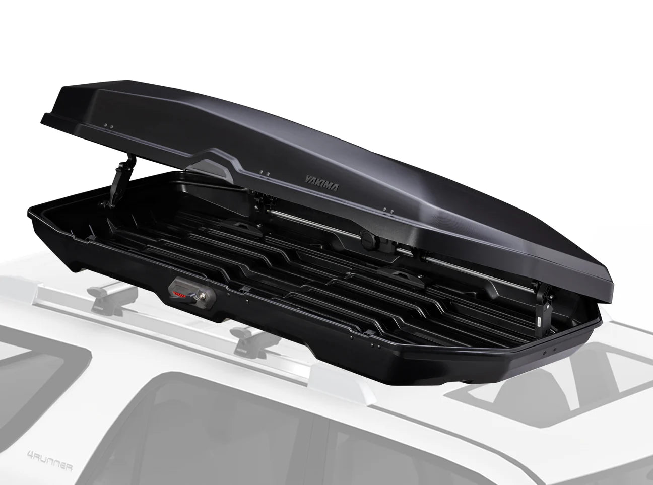 The Yakima CBX 16, an open rooftop cargo carrier, is installed on a vehicle, highlighting its generous interior storage capacity and reliable locking system.