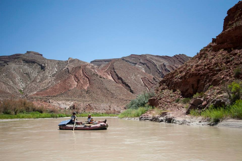two people in a raft on a river.