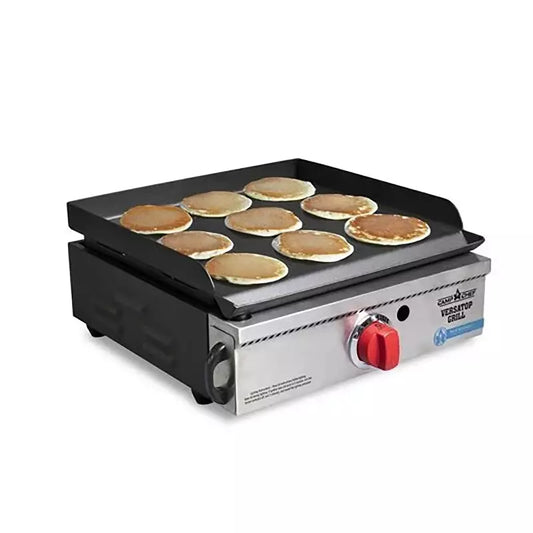 A VersaTop 14 Flat Top Camp Stove with pancakes cooking on it, featuring a non-stick True Seasoned surface.