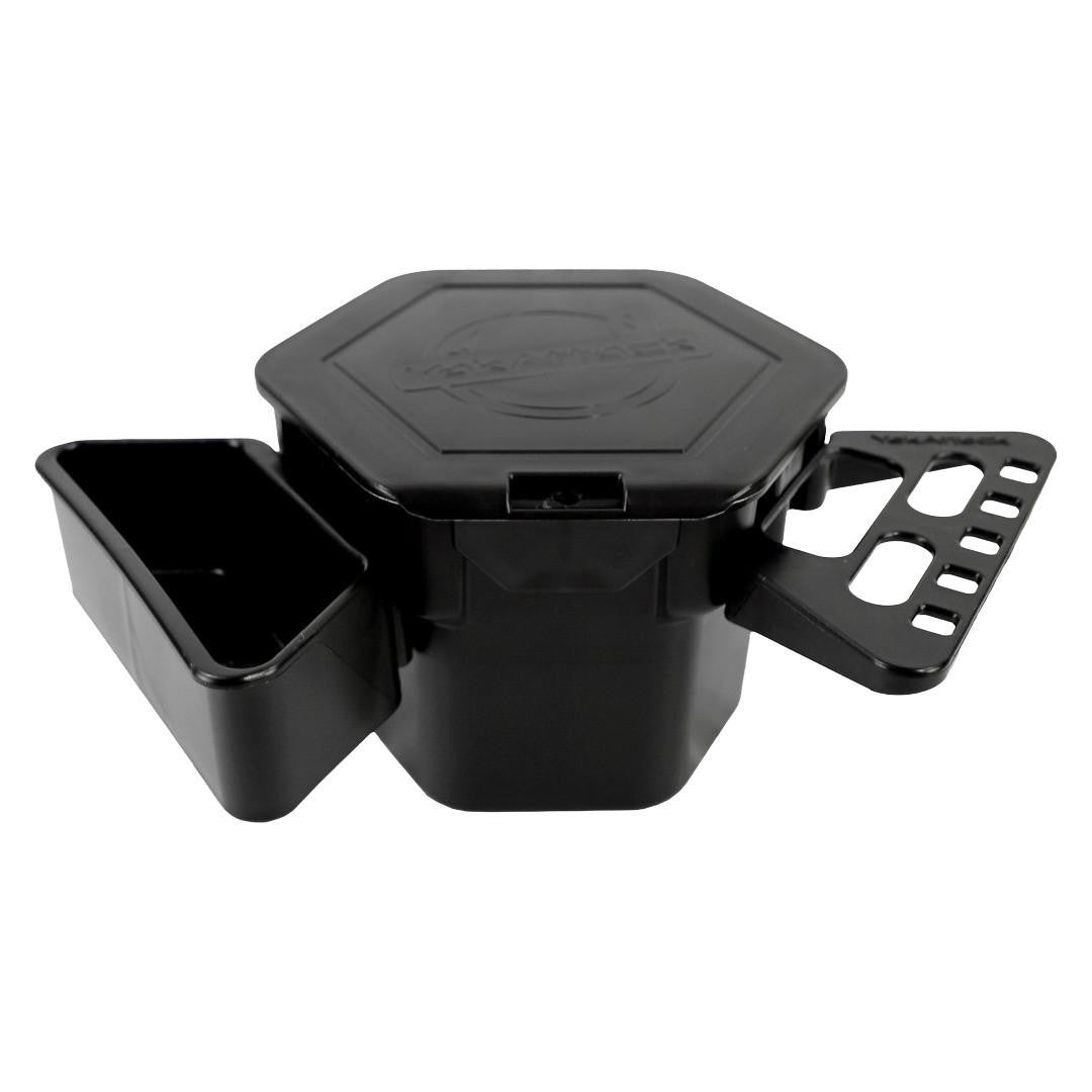 The YakAttack MultiMount PRO Cup Holder is a black plastic, hexagonal cup holder with a hinged lid and two side compartments—one solid and one perforated—ideal as a modular kayak accessory for any angler’s workstation.