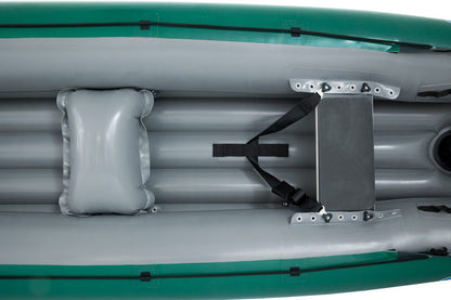 Top view of the Gumotex Baraka Inflatable Canoe in gray with a green exterior, showcasing seating areas, one featuring a padded seat, and black straps securing various components. This whitewater canoe is designed with a self-bailing bottom for added safety and convenience.