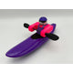The Foamie Friends Foamie Creeker features a small toy figure in a purple kayak with a black paddle—wearing a purple cap and pink vest—perfect for river play and adventure.