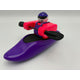 A Foamie Friends toy figure in a helmet and life jacket steers the Foamie Play Boat, holding a black double-bladed paddle and ready for river adventures.