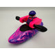 A Foamie Friends Swirl Play Foamie Boaters toy features a figure in a pink and purple marbled boat with a black paddle, wearing a pink vest and purple helmet, set against a plain background.