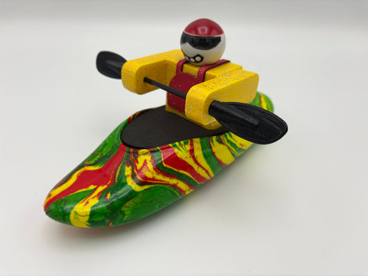 The Foamie Friends Swirl Play Foamie Boaters features a toy figure in a yellow life vest with a black oar in a red, green, and yellow swirl-patterned boat—perfect for imaginative play.